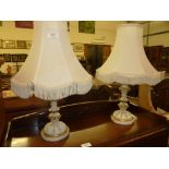 A pair of painted and decorated wooden table lamps