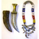 A Middle Eastern dagger and an Indonesian necklace