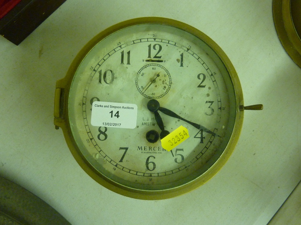 A ship's brass cased single hole clock