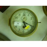 A ship's brass cased single hole clock