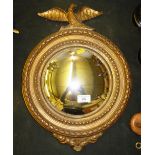 A gilt framed convex wall mirror mounted with a bi