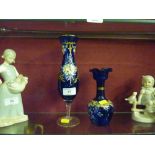 A pair of overpainted blue glass vases