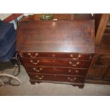 An 18th Century oak bureau fitted four long drawer