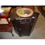 An oak veneered corner cabinet