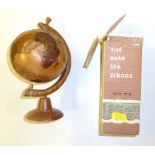 A small wooden puzzle globe and a box of 'The Dead