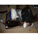 A box of various handbags and a vanity case