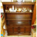 An Ercol bookcase fitted two doors below