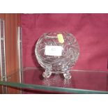 A cut glass bowl raised on three feet