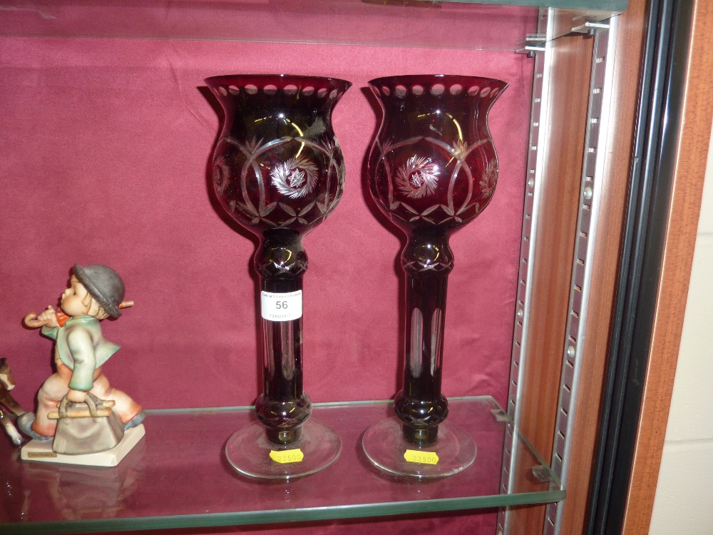 A pair of ruby glass lustres