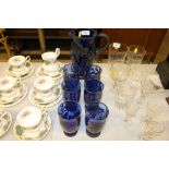 A blue glass and white metal overlaid lemonade set