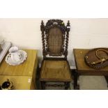 A Victorian carved oak and cane seated hall chair