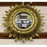 A gilt metal convex wall mirror