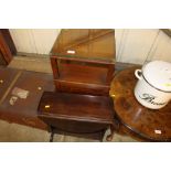 A small drop leaf coffee table and a bedside cabin