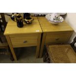 A pair of light oak bedside tables fitted single d