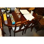 A reproduction mahogany extending dining table wit