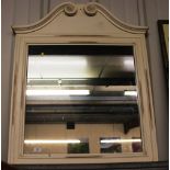 A large painted wall mirror with scroll pediment