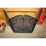 A large wrought iron folding spark guard