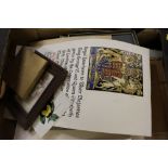 A box containing various pictures and prints and a