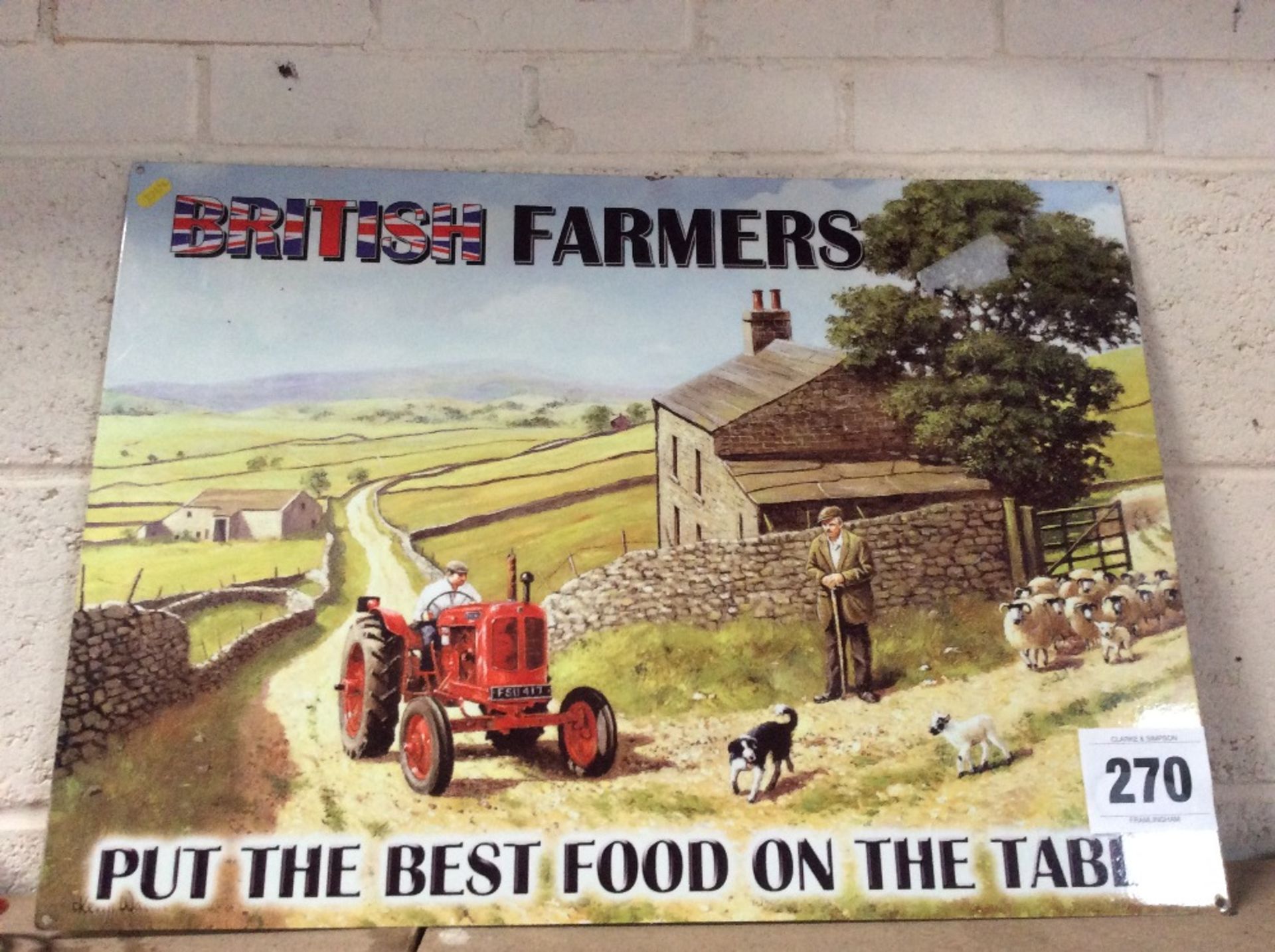 Metal sign depicting Nuffield tractor in rural setting.