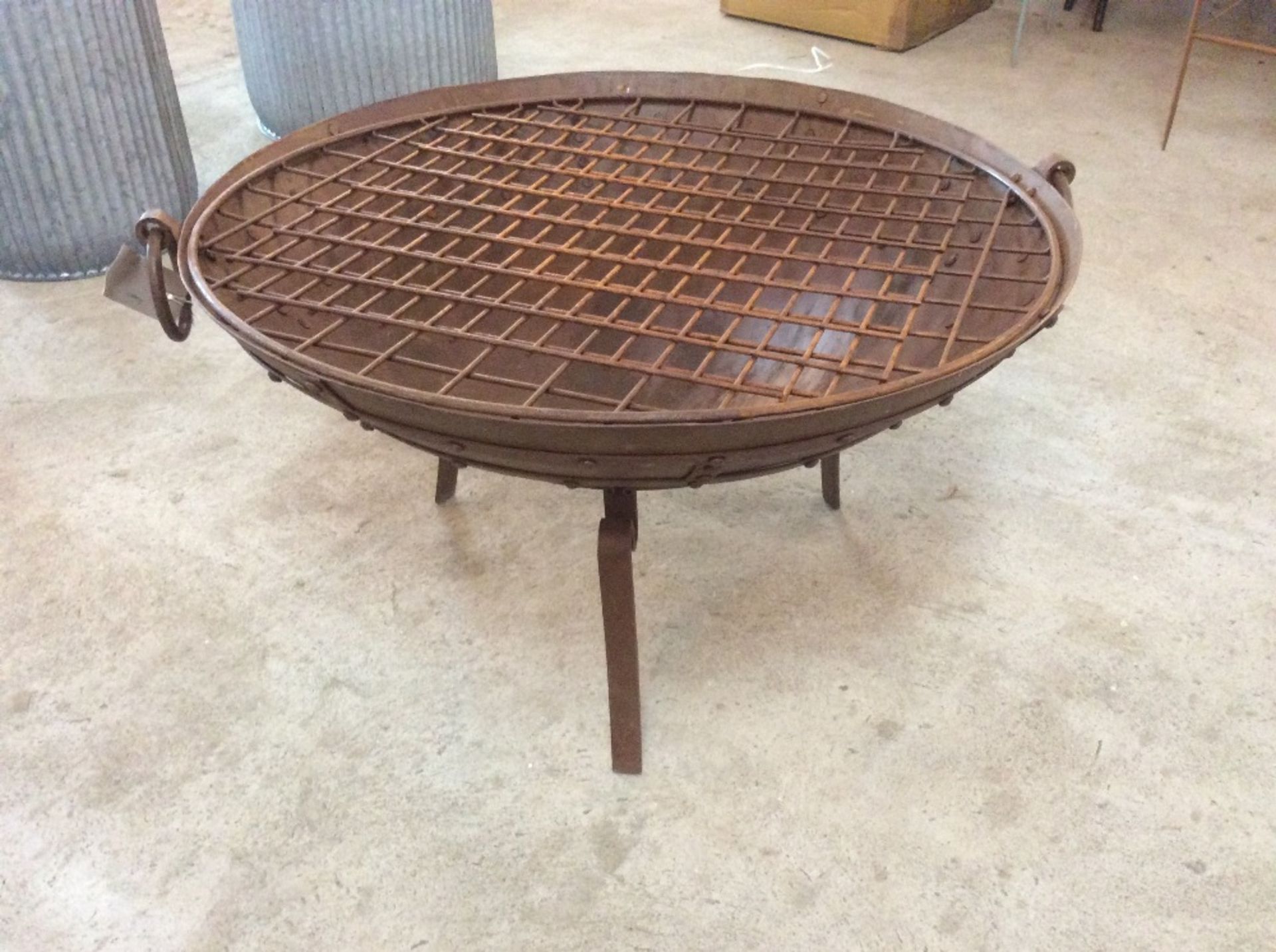 Aged fire pit on stand with grill
