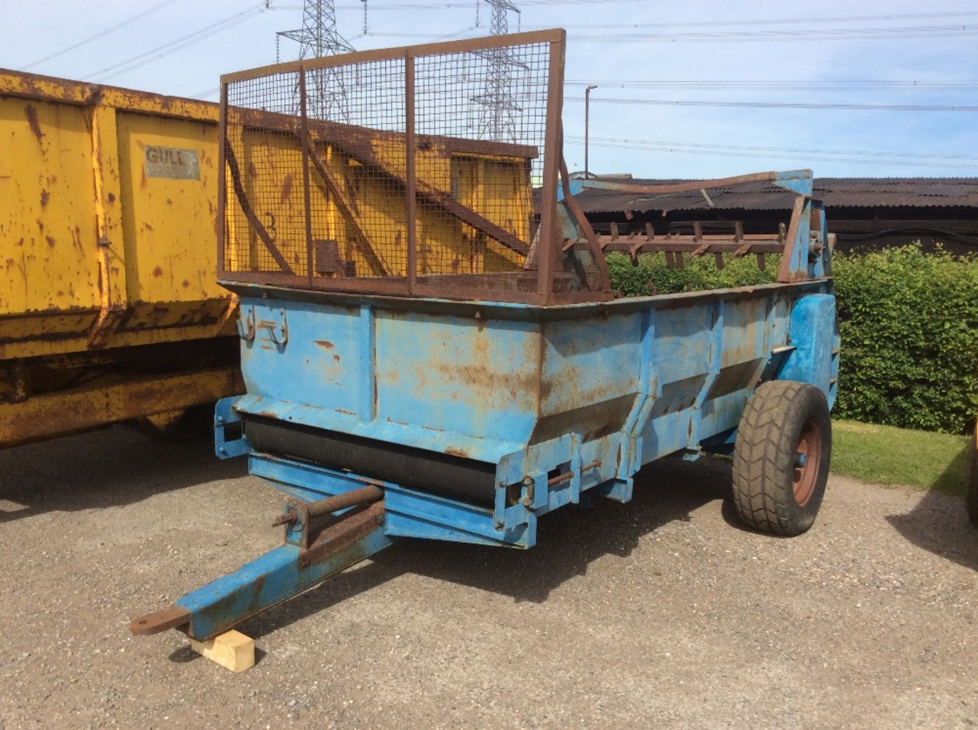 Kidd single axle rubber belt muck spreader.