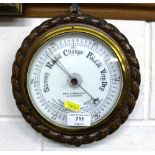 A carved oak barometer by George E Wolsey of Gt.