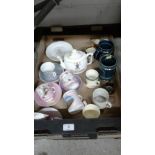 A box of souvenir mugs; cups and saucers etc.