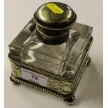 A silver plated glass inkwell