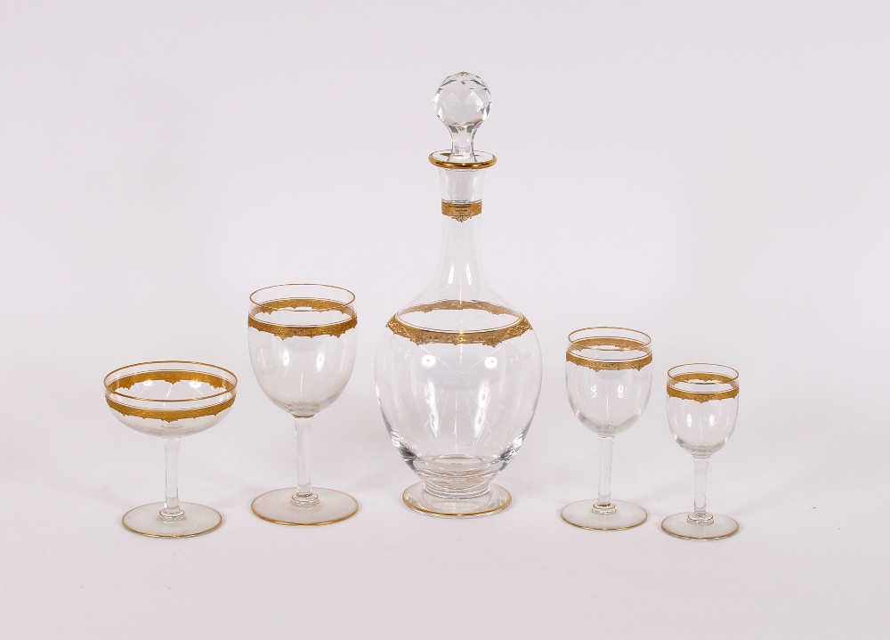 A part suite of mid 20th Century glassware, with gold leaf banded decoration, comprising 2 decanters