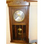 A 20th Century oak cased two hole wall clock