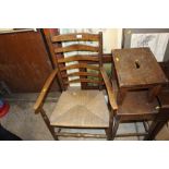 An oak ladder back and rush seated elbow chair