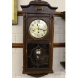 A 20th Century oak three hole wall clock