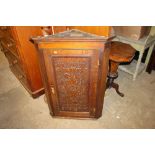 A 19th Century carved oak hanging corner cupboard