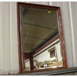 A faux wooden and gilt decorated wall mirror