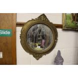 A Regency style gilt framed convex wall mirror; an