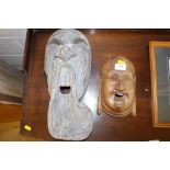 Two carved wooden face masks