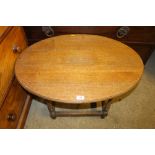A small oak oval topped coffee table