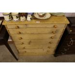 A stripped pine chest fitted six graduating drawer