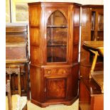 A reproduction mahogany and glazed corner cabinet