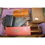 A large brown leather suitcase containing various