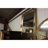 A large gilt framed and bevel edged wall mirror