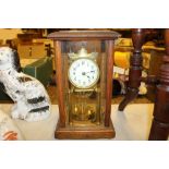 An oak cased anniversary clock