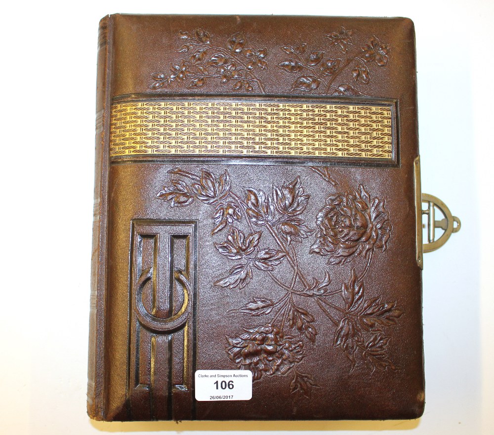 A Victorian leather bound photo album lacking cont