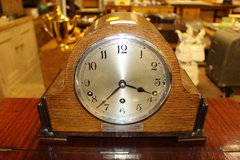 A 1930's oak cased three hole mantel clock with pr