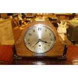 A 1930's oak cased three hole mantel clock with pr