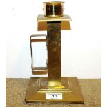 An Art Deco brass candlestick raised on square foo