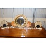 An Art Deco marble mantel clock with a pair of mat