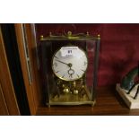 A brass and glass anniversary clock