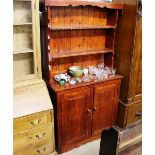 A stained pine kitchen dresser