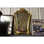 A gilt framed wall mirror; and a mahogany framed m